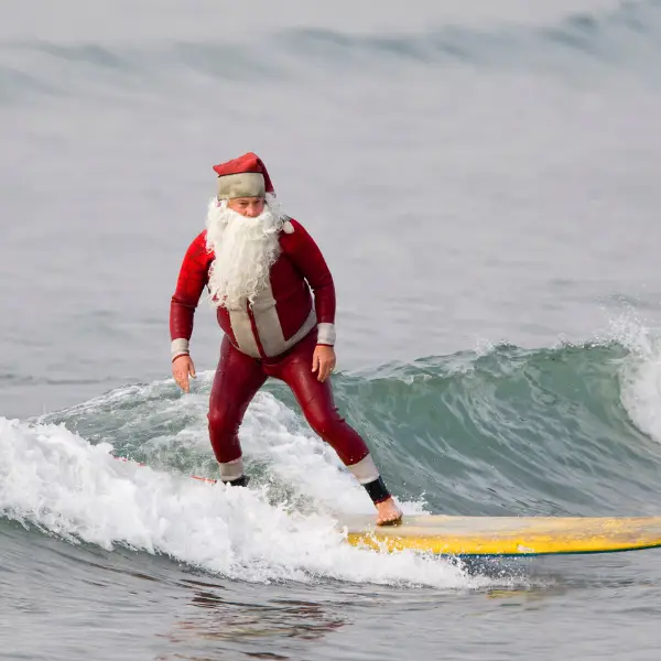 Santa is Surfing to Christmas Parades in Newport Beach, Long Beach and Seal Beach